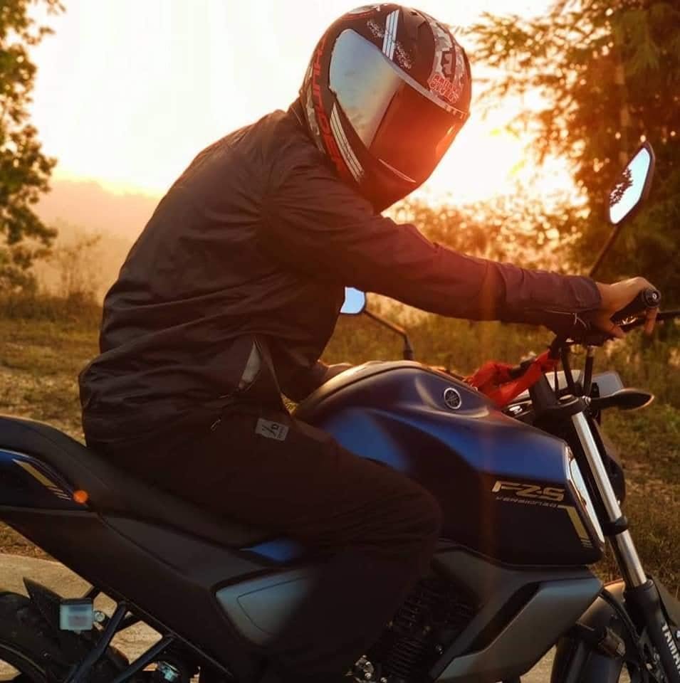 Bikram Bishwakarma riding a motorcycle at sunset